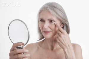 Beauty portrait of senior woman looking in mirror
